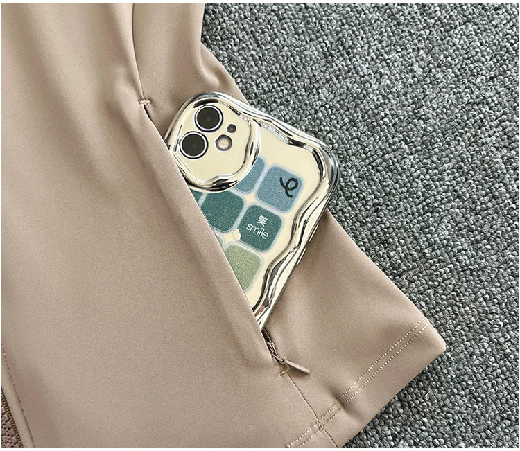 Close-up of pocket on women's high-end exercise jacket by KiKis holding a smartphone with a colorful case