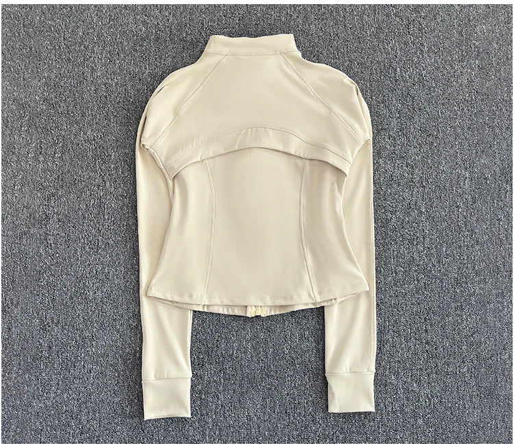 KiKis cream women's high-end exercise jacket with long sleeves and fitted design laid flat