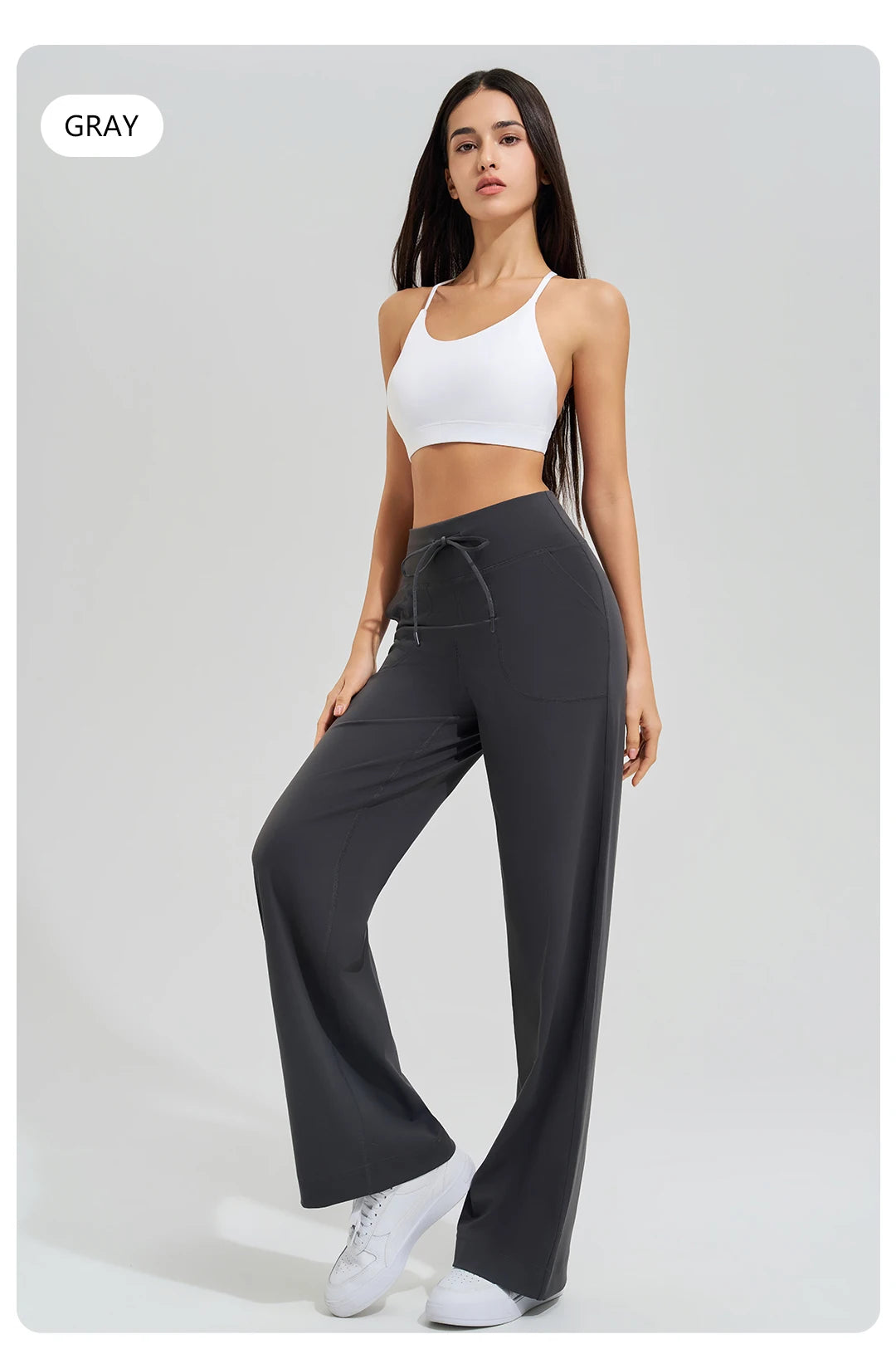 KiKis Women's High Waist Loose Running Yoga Pants in gray worn with white sports bra and sneakers
