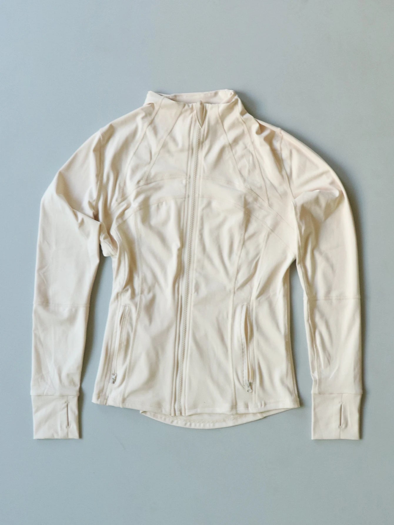 KiKis women's lightweight zipUp activewear jacket in off-white with front zipper and thumb holes