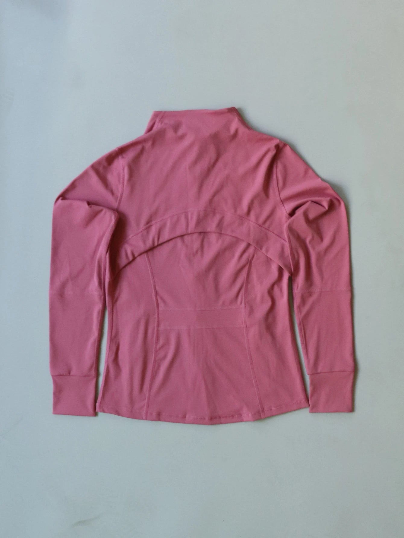 KiKis women's lightweight zipUp activewear jacket in pink laid flat showing back side