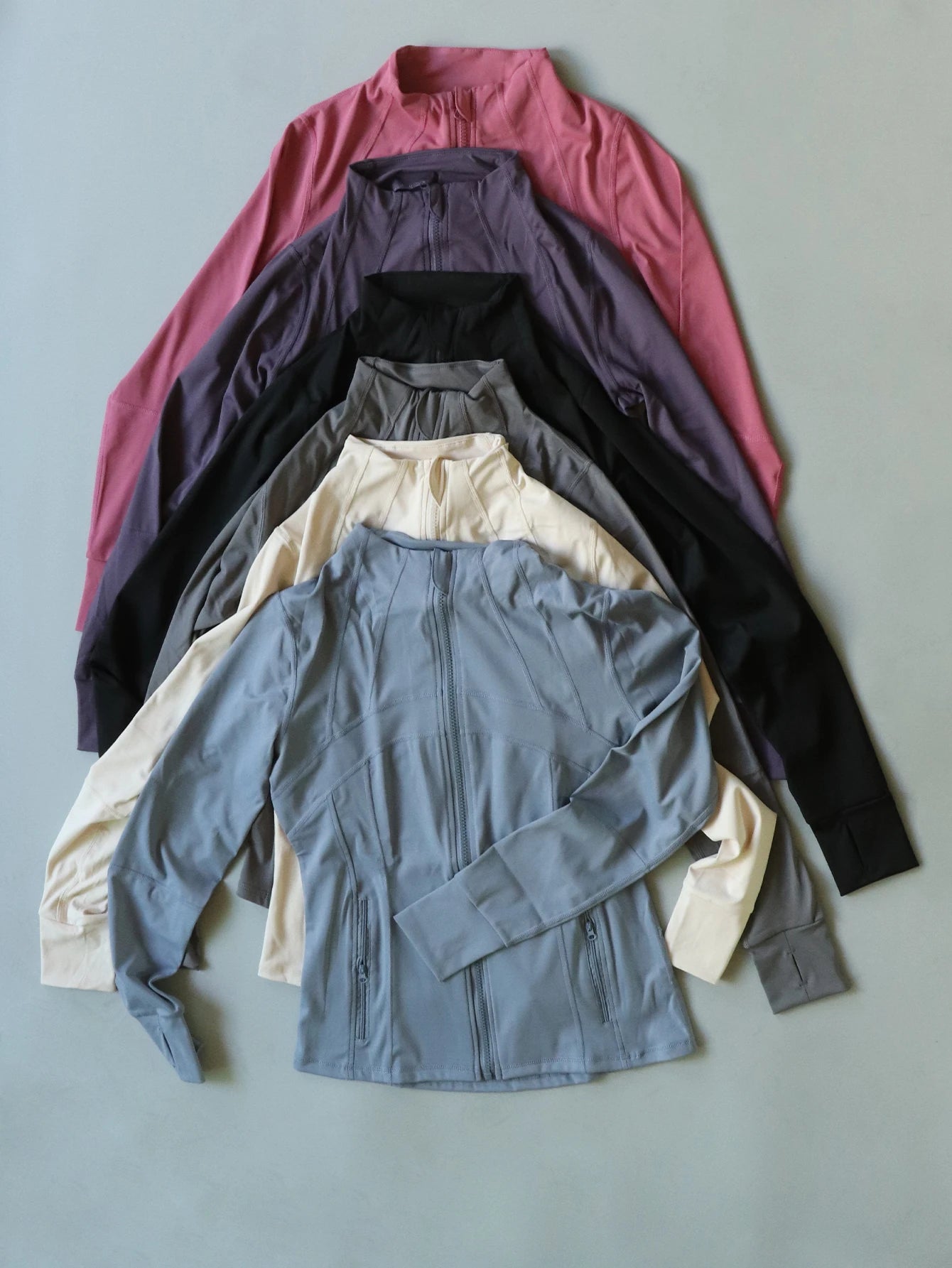 KiKis Women's Lightweight ZipUp Activewear Jacket in multiple colors displayed flat with front zipper