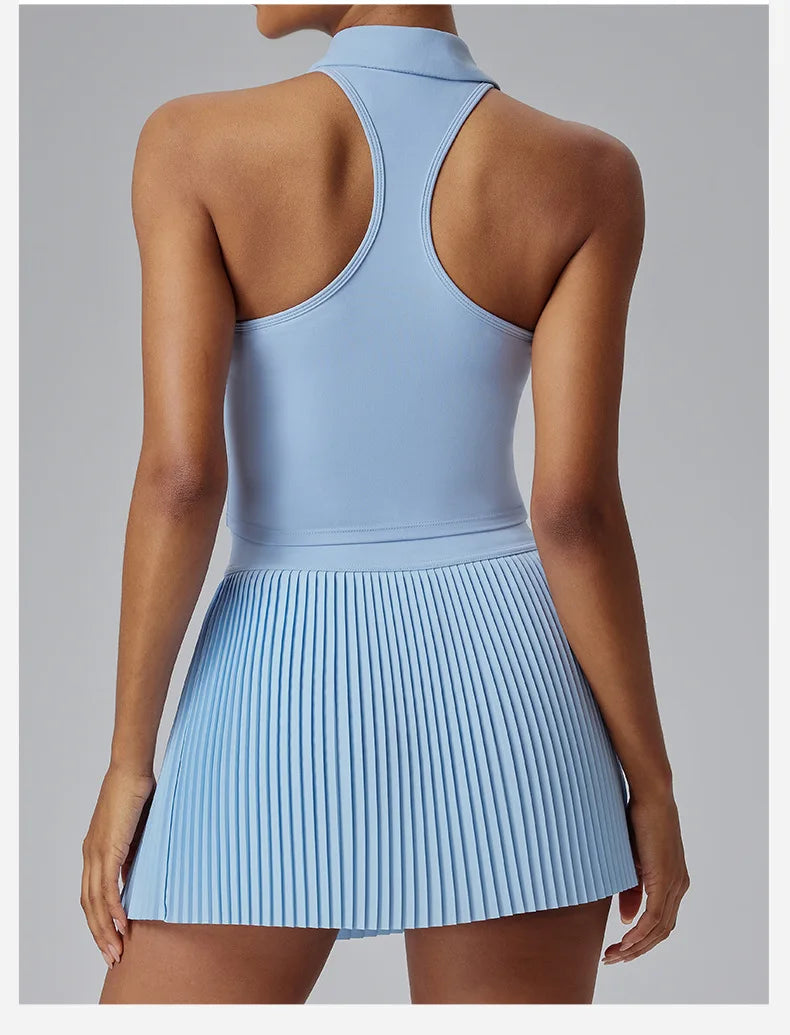 KiKis Women's Organ Pleated Tennis Skirt in light blue worn with a sleeveless racerback top