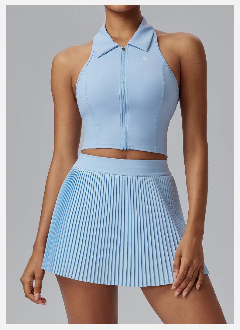 KiKis Women's Organ Pleated Tennis Skirt in light blue with a fitted matching zip-up crop top