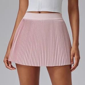 KiKis Women's Organ Pleated Tennis Skirt in light pink with high waist and fine pleats