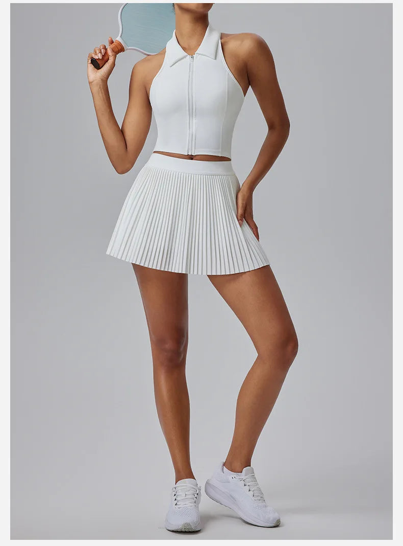 Women's Organ Pleated Tennis Skirt in white styled with sleeveless zip-up top and white sneakers