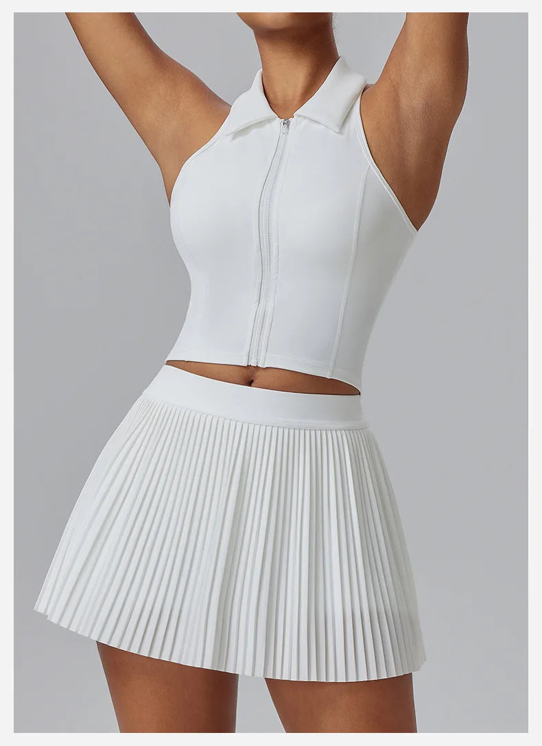 White Women's Organ Pleated Tennis Skirt by KiKis styled with a sleeveless zip-up crop top