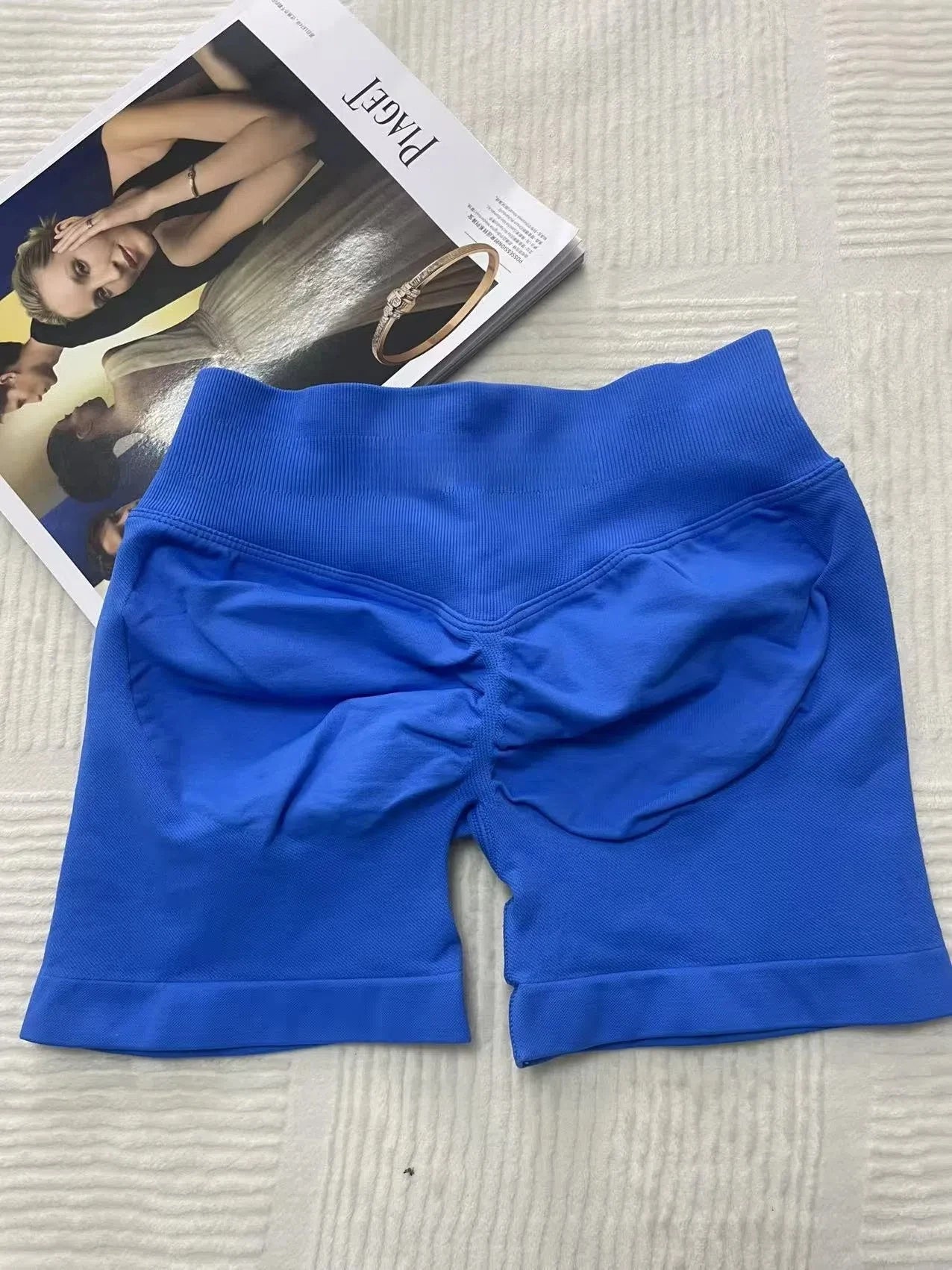 KiKis women's peach hip yoga shorts in blue with ruching detail and high waistband