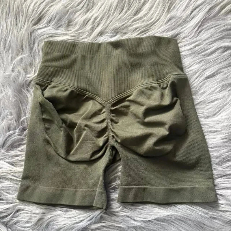 KiKis women's peach hip yoga shorts in olive green with ruched back detail on soft fabric