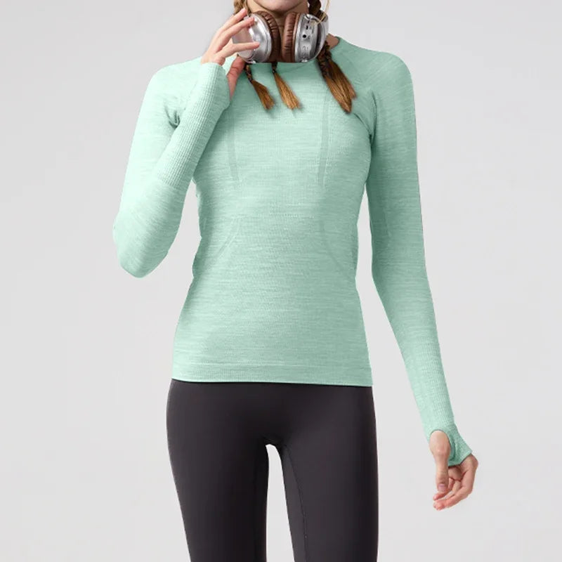 KiKis women's quick dry workout shirt in light green with long sleeves and thumb holes