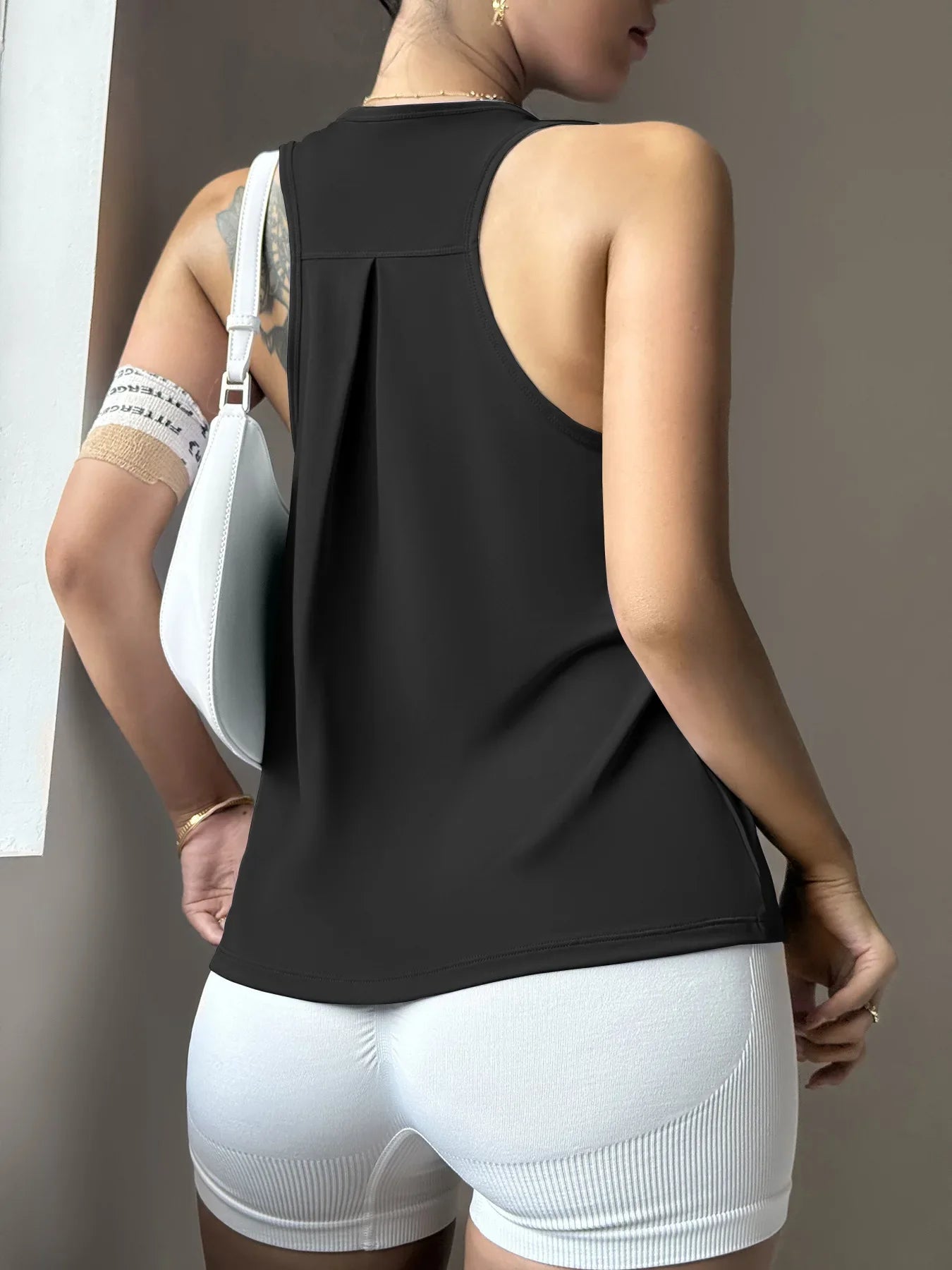 KiKis women's quick dry yoga top in black with sleeveless design perfect for active workouts
