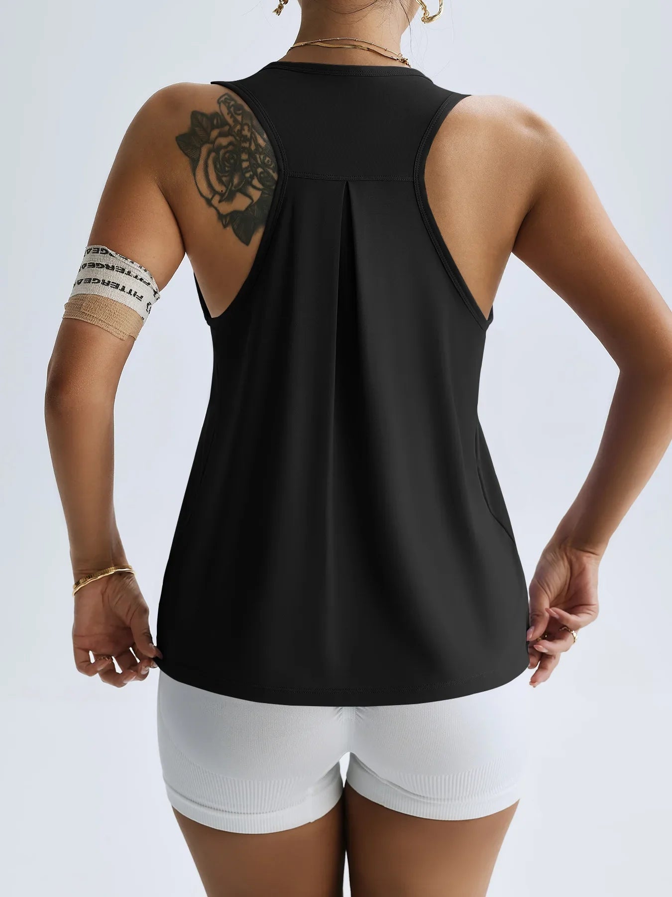 Back view of women's quick dry yoga top in black with racerback design by KiKis