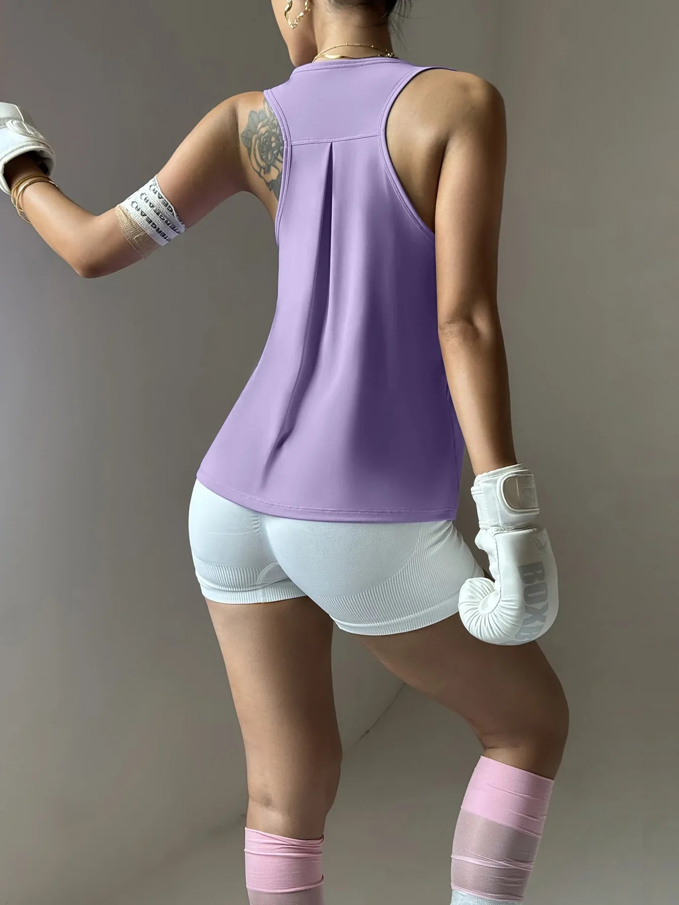 KiKis women's quick dry yoga top in lavender shown from back with racerback design