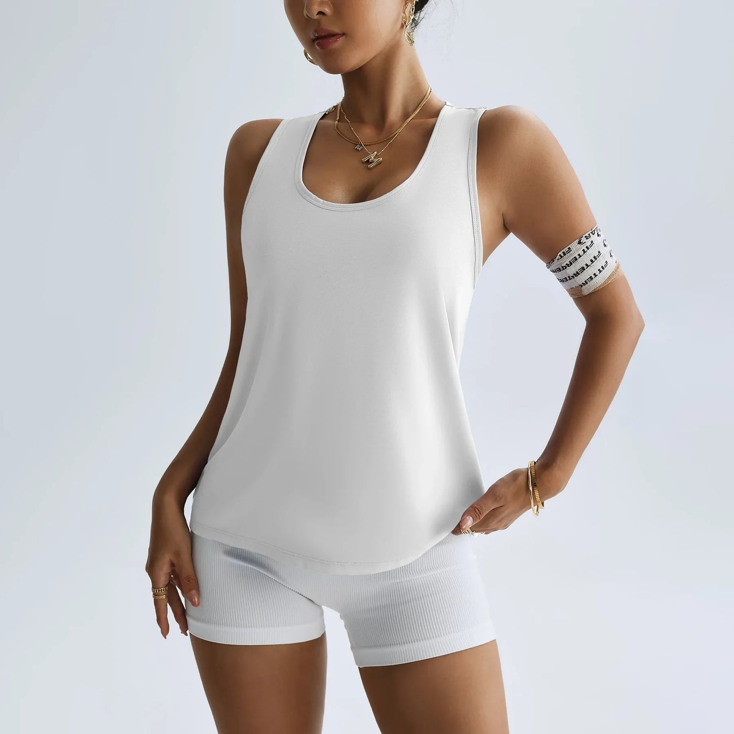 KiKis women's quick dry yoga top in white sleeveless design paired with matching shorts