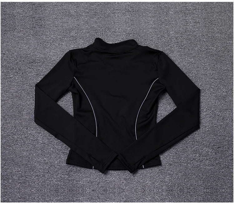 KiKis women's reflective yoga jacket in black with long sleeves and reflective piping detail