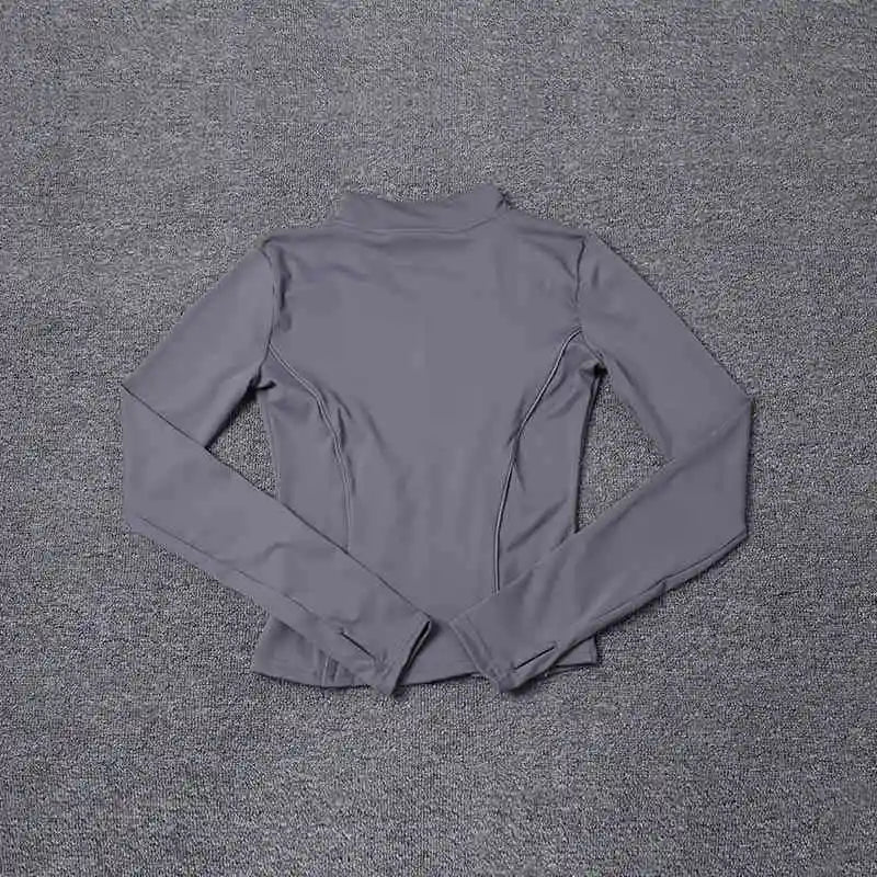 KiKis women's reflective yoga jacket in gray with long sleeves and thumb holes laid flat