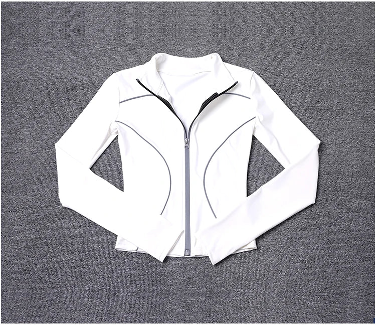 White women's reflective yoga jacket with full zipper and black trim details laid flat