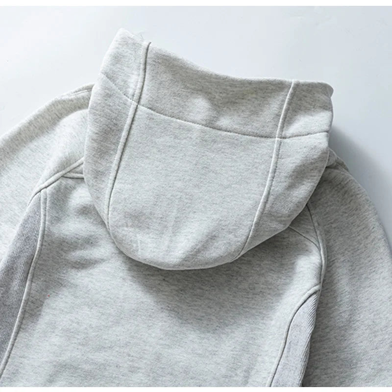 Light gray women's running zip up hoodie by KiKis showing close-up of hood and shoulder seams