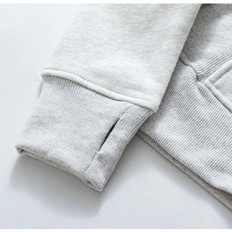 Close-up of sleeve cuff detail on light gray women's running zip up hoodie by KiKis