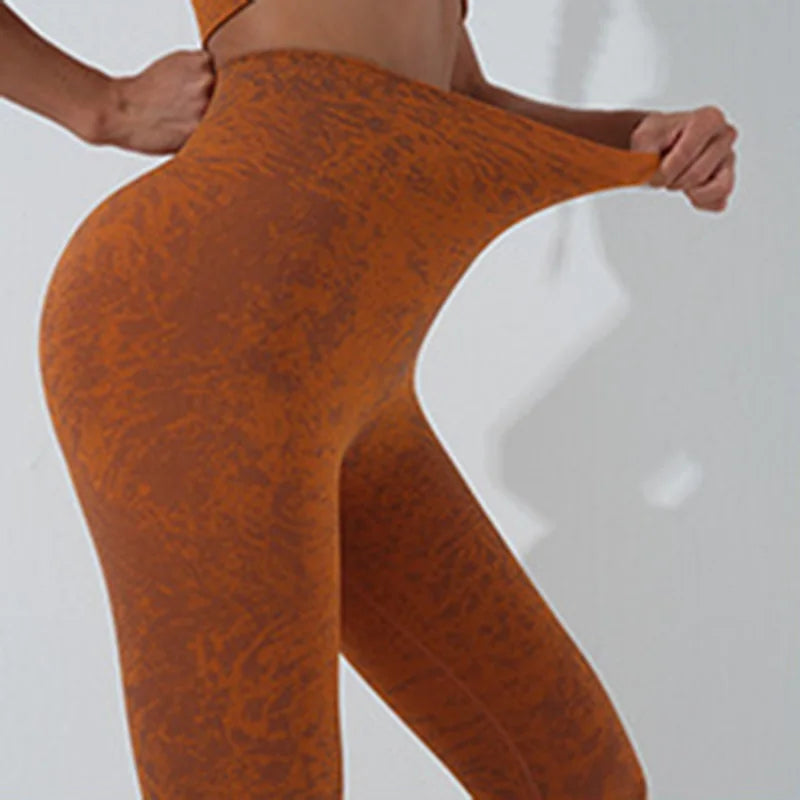 KiKis women's seamless yoga set in rust orange showing stretchable high-waist leggings fabric