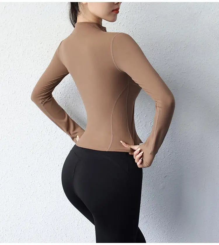 KiKis women's slim fit yoga jacket in brown worn with black leggings showing back view