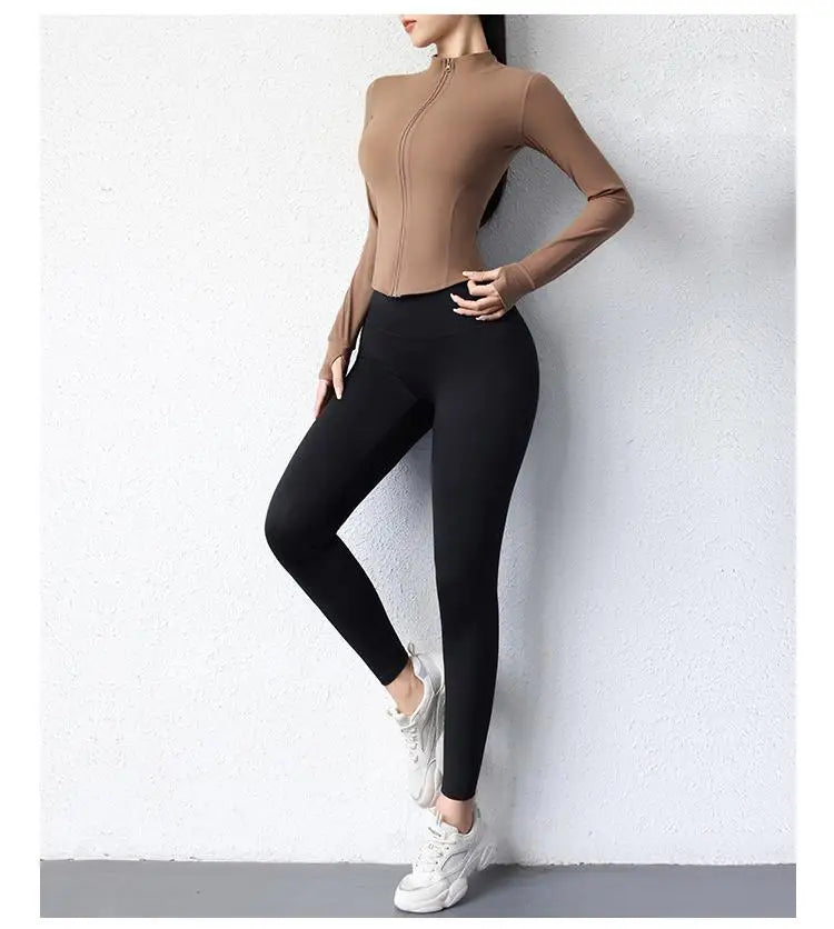 KiKis women's slim fit yoga jacket in brown paired with black leggings and white sneakers
