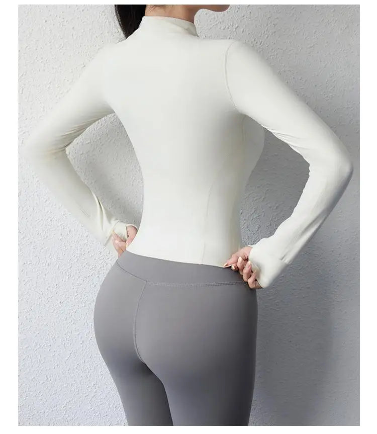 KiKis women's slim fit yoga jacket in white shown from the back with long sleeves and fitted design
