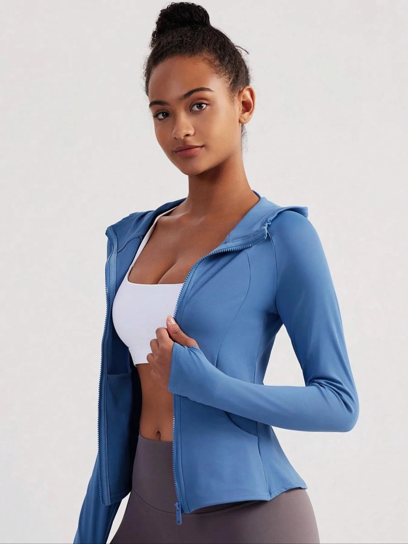 KiKis women's thumb hole sports jacket in blue with front zipper and fitted design