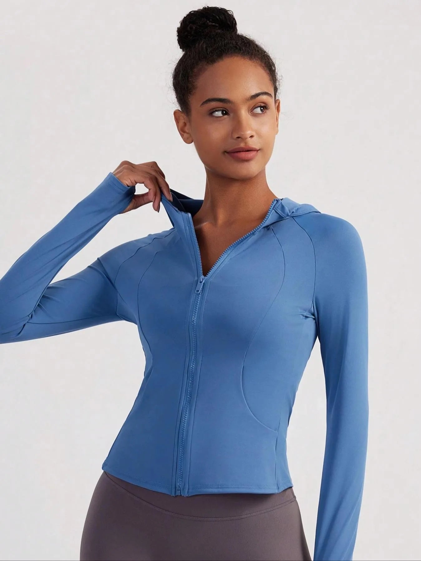 KiKis women's thumb hole sports jacket in blue with front zipper and fitted design
