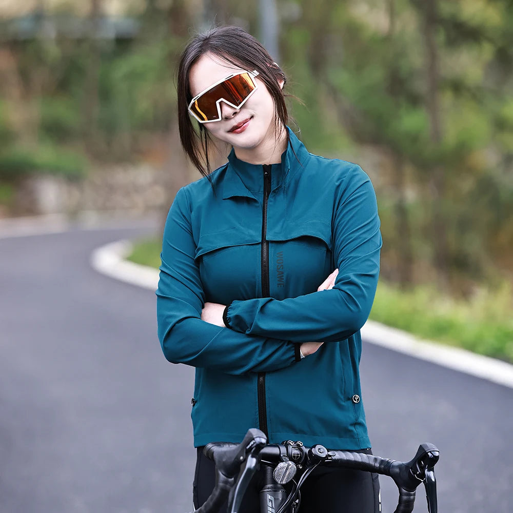 KiKis Women's Reflective Cycling Jackets in teal with full zipper and standing collar worn by a cyclist