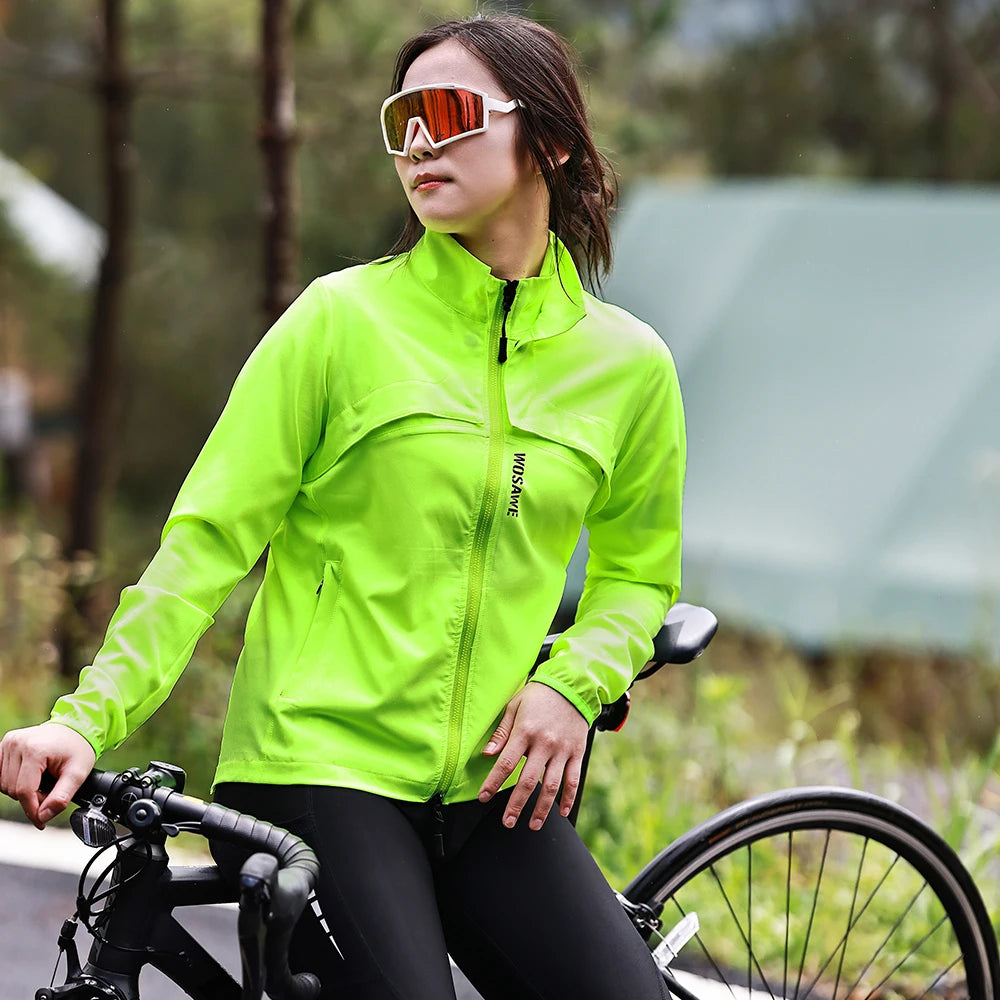 Woman wearing bright green Women's Reflective Cycling Jackets by KiKis sitting on a road bike outdoors