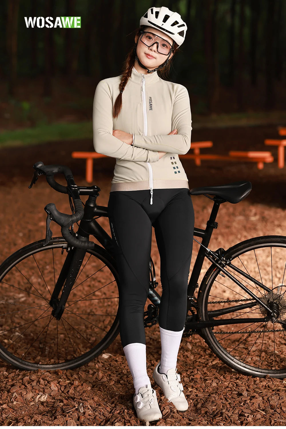 Wosawe women's winter cycling jacket beige with full zipper worn by cyclist standing next to black road bike