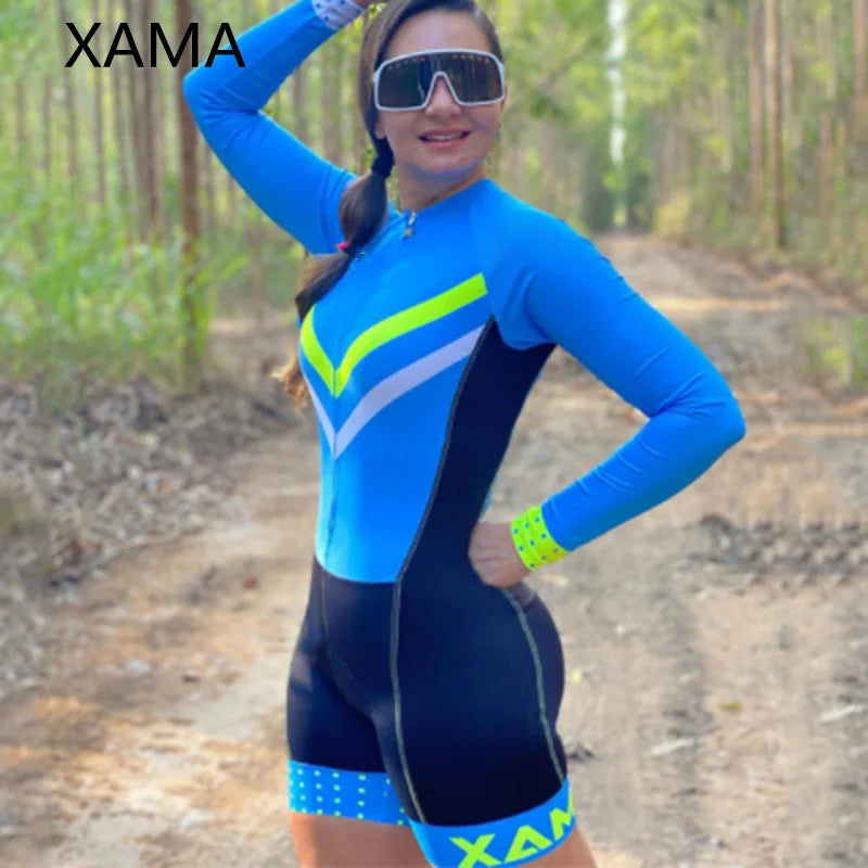 XAMA women's cycling jumpsuit in blue with neon yellow and white accents worn outdoors