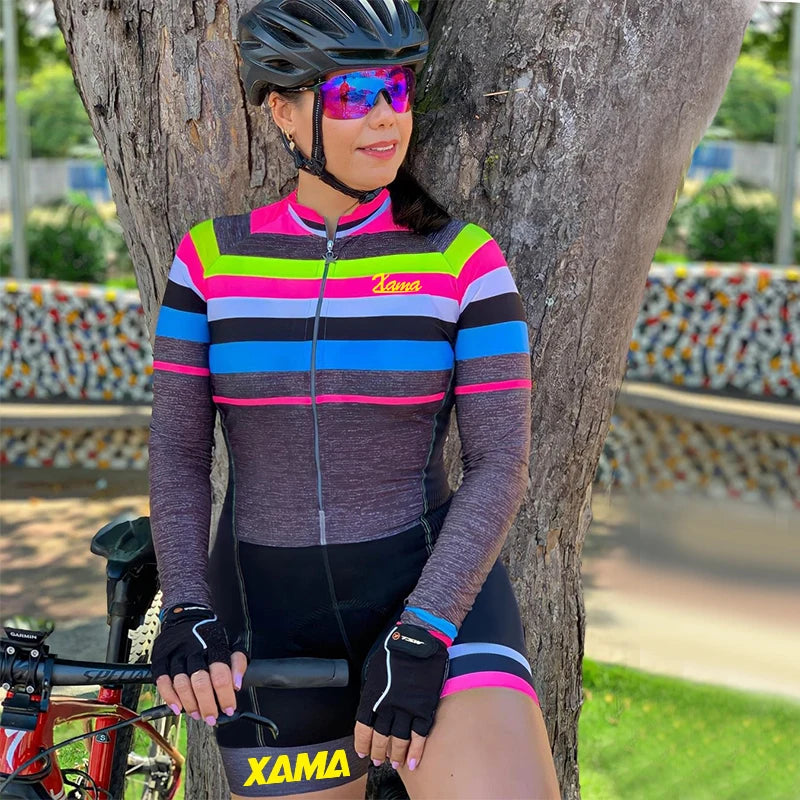 XAMA women's cycling jumpsuit with colorful striped design and full zip front worn by cyclist with helmet