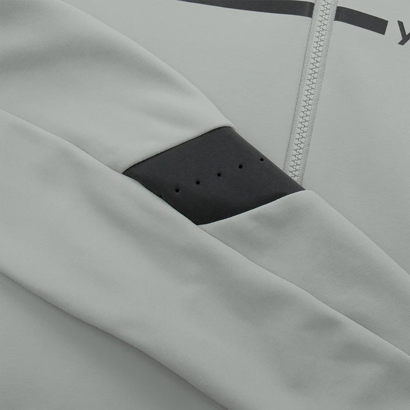 Close-up of women's thermal cycling jacket sleeve in light gray with black ventilated panel by KiKis