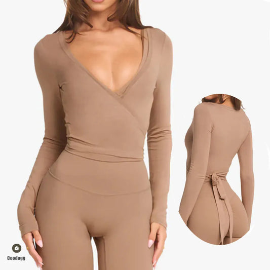 KiKis women's cross wrap yoga shirt in beige with long sleeves and tie back detail