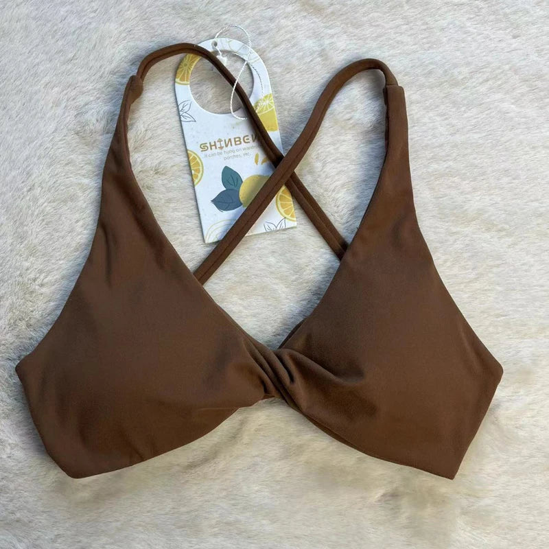 KiKis brown padded front twist sports bra with cross back straps on neutral background