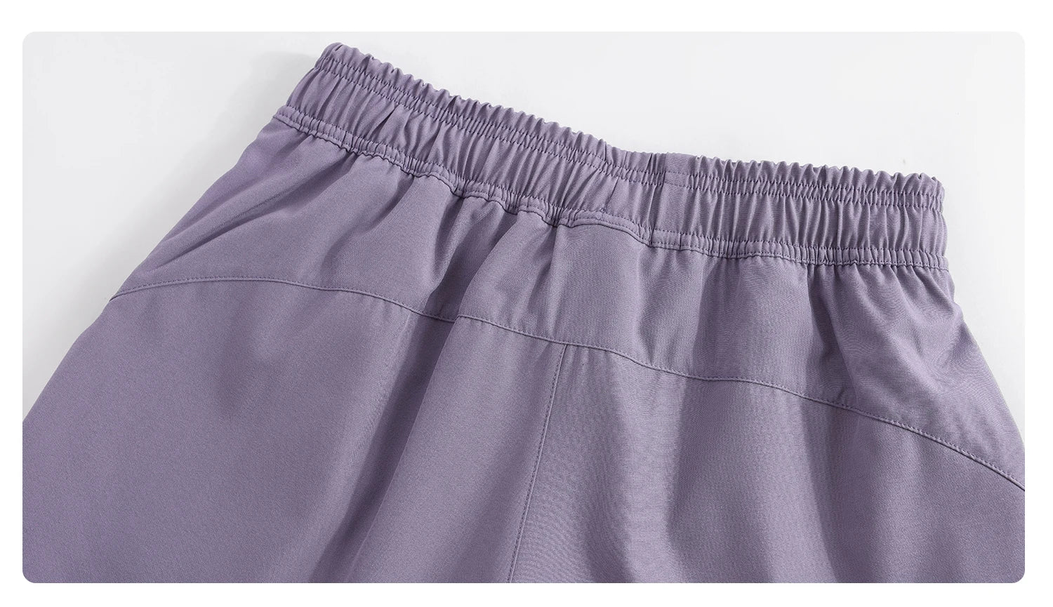 Close-up of purple KiKis high waist running shorts for women showing elastic waistband detail