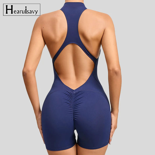 KiKis sleeveless workout romper in navy blue with open back design and ruched detail on shorts