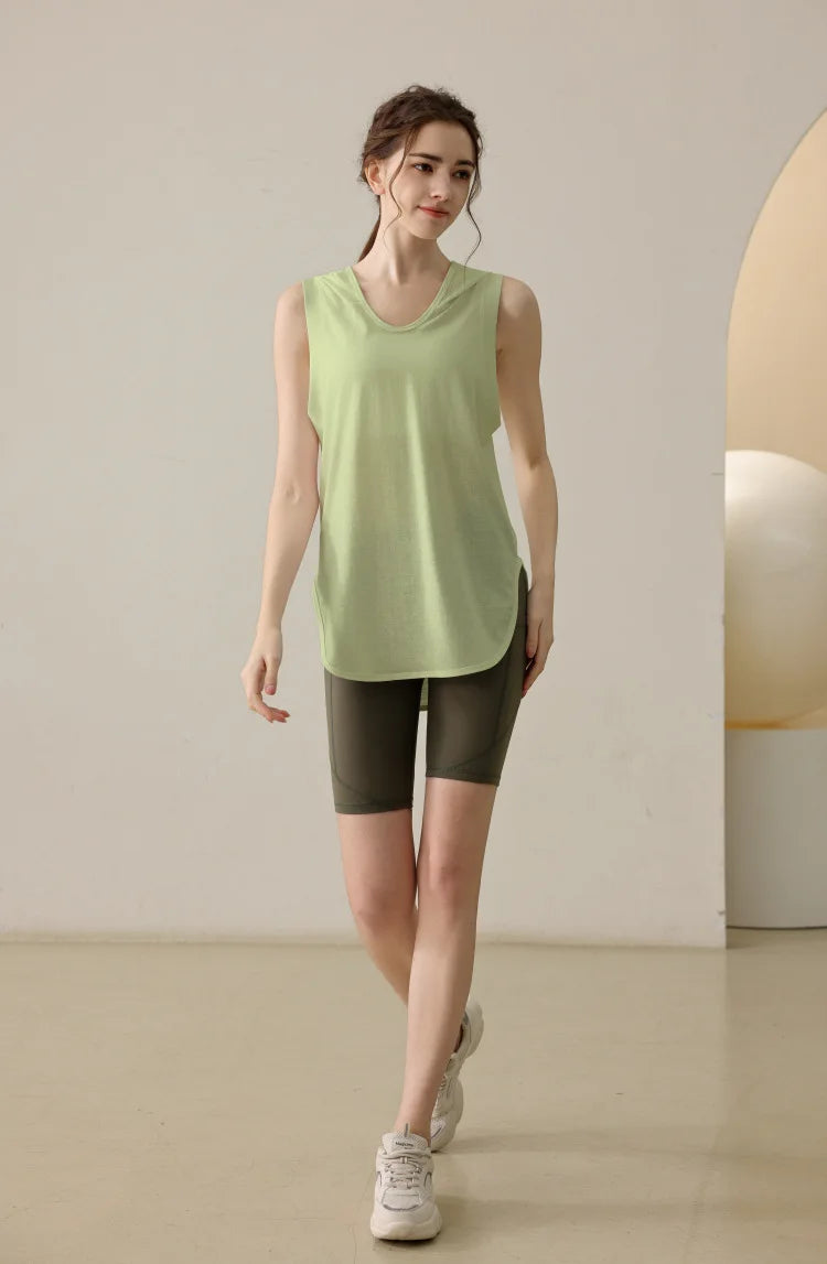 KiKis summer sleeveless workout hoodie in light green worn with dark shorts and white sneakers