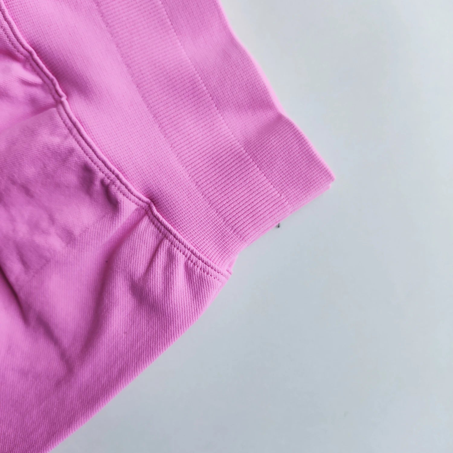 Close-up of pink Woman Scrunch Bum Flare Leggings showing scrunched detail and stitching