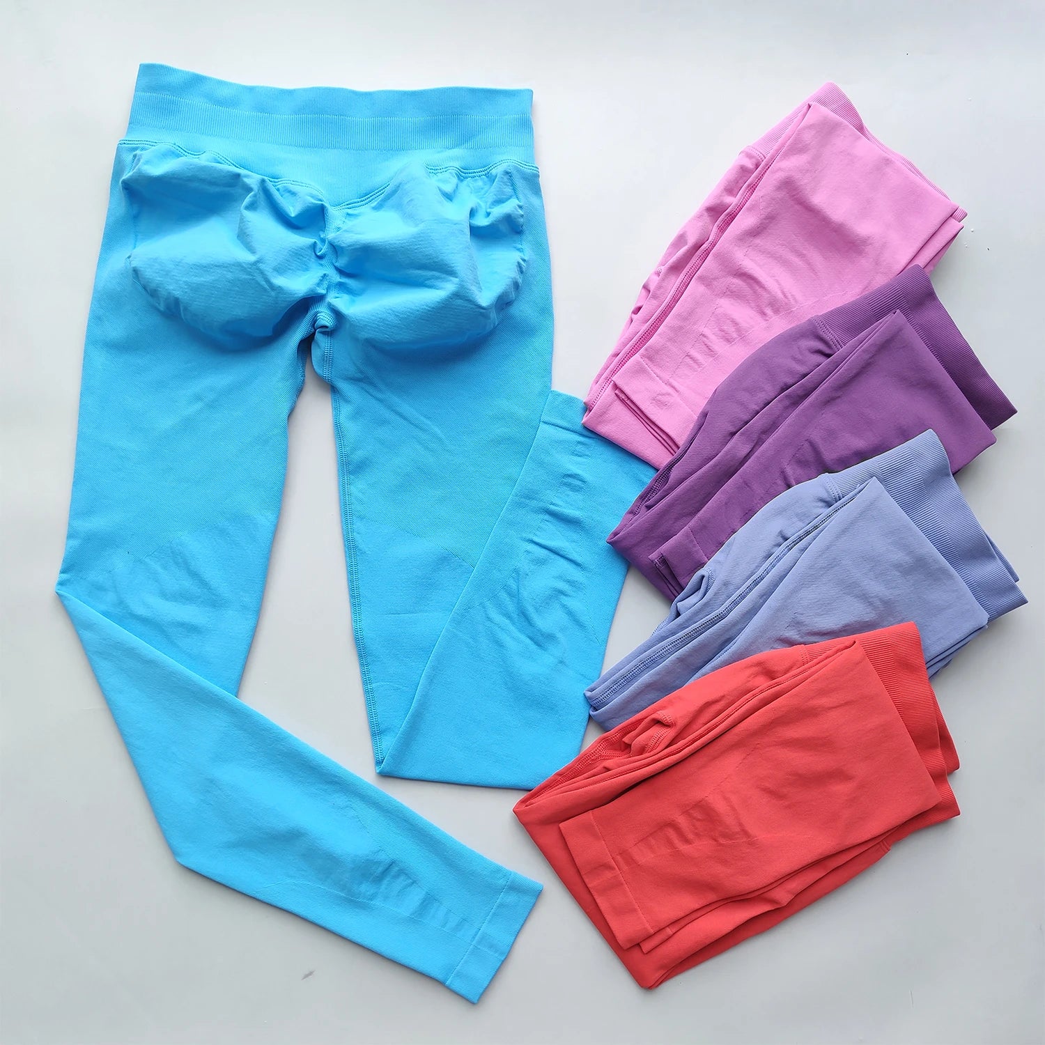 KiKis Woman Scrunch Bum Flare Leggings in multiple colors including blue, pink, purple, and orange
