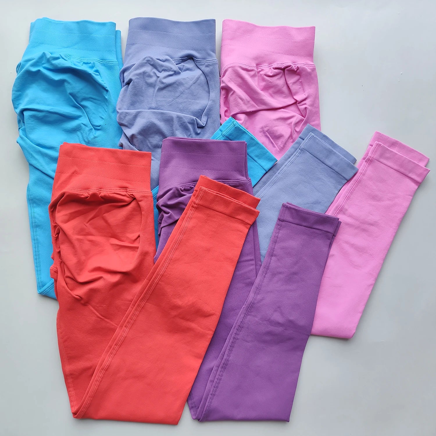 KiKis Woman Scrunch Bum Flare Leggings in blue purple pink red and lavender colors neatly folded