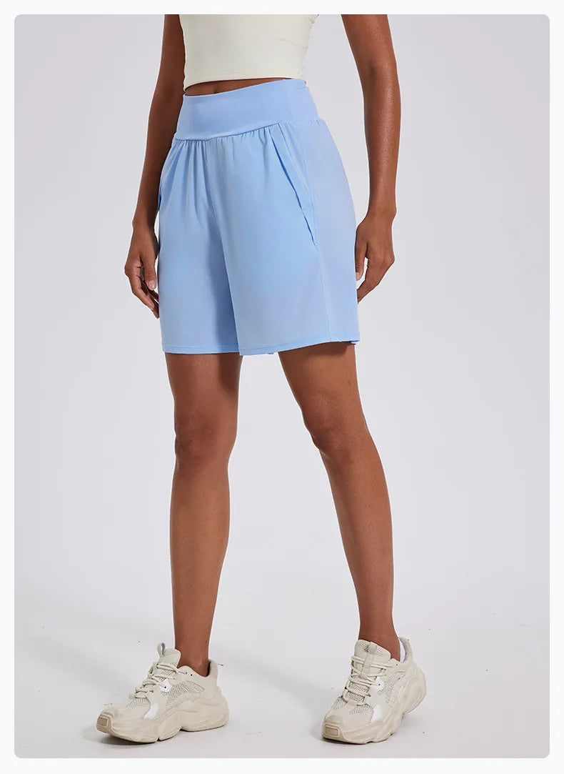 Light blue women's high waist running shorts with side pockets worn with white sneakers