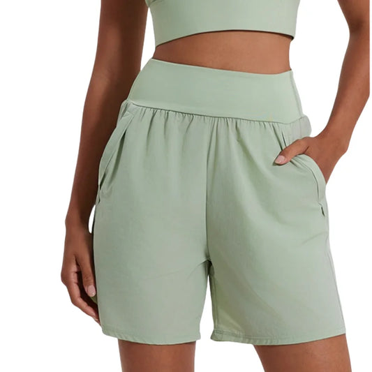KiKis women's high waist running shorts in light green with side pockets and comfortable fit