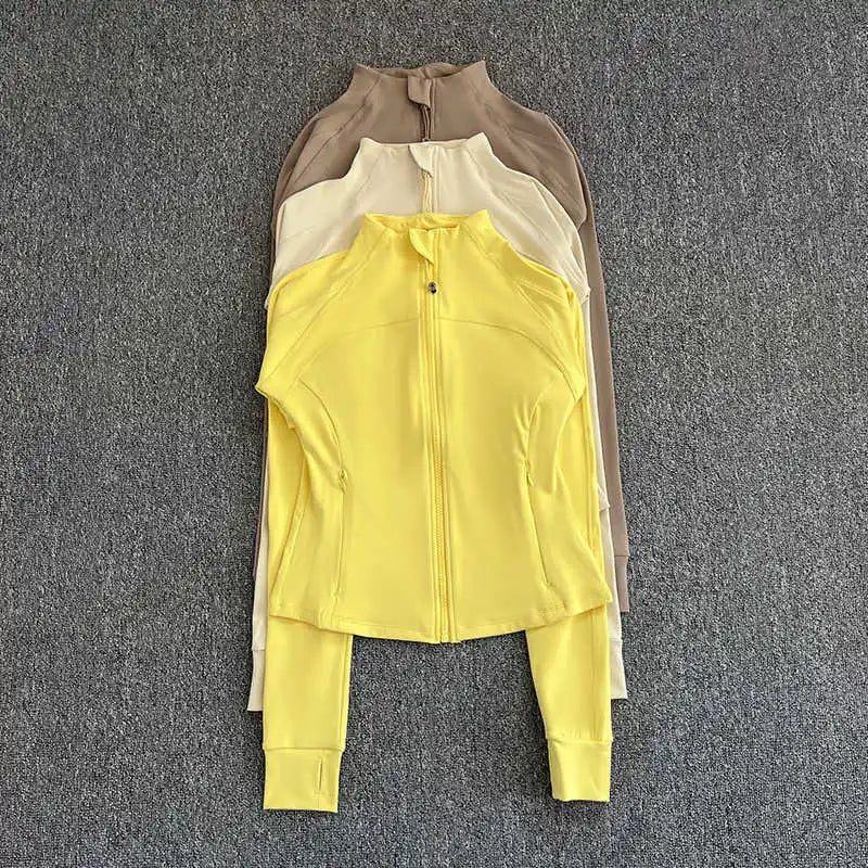 KiKis women's high-end exercise jacket in yellow, cream, and brown colors displayed flat on gray background