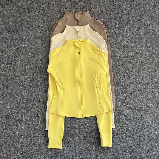 KiKis women's high-end exercise jacket in yellow, cream, and brown colors displayed flat on gray background