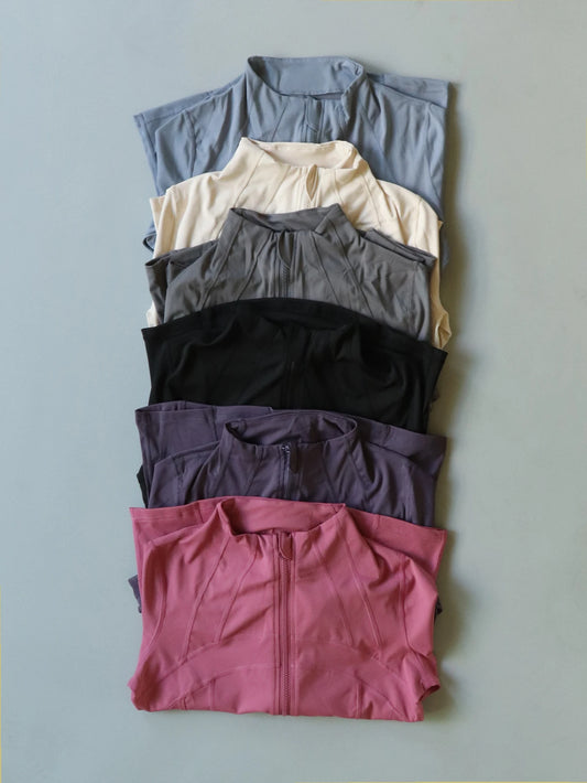 KiKis women's lightweight zipup activewear jackets in various colors neatly folded