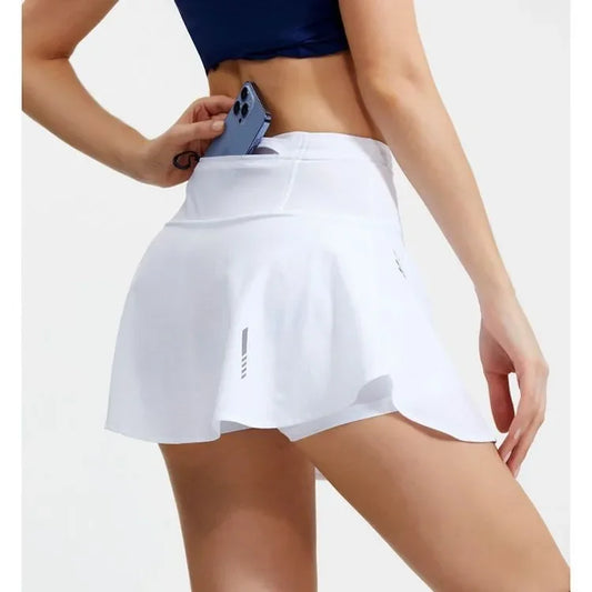 KiKis women's quick dry tennis skirt in white featuring a back pocket holding a smartphone