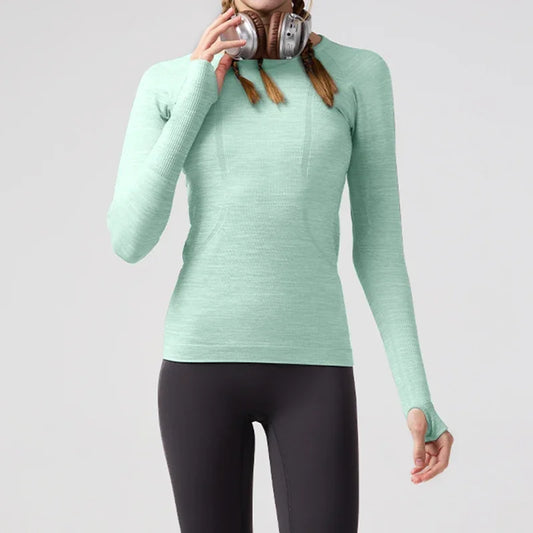 KiKis women's quick dry workout shirt in light green with long sleeves and thumb holes